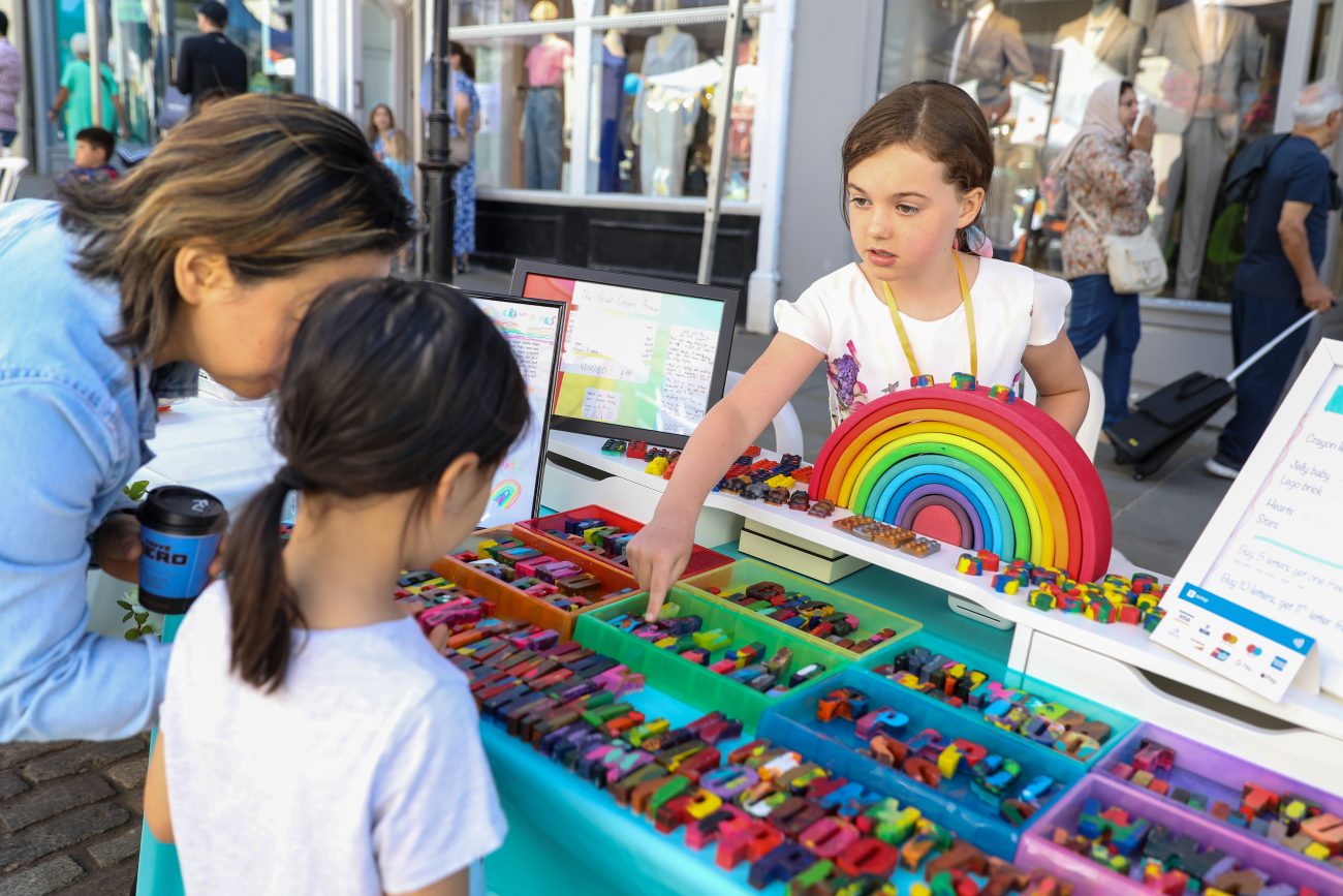 Young entrepreneur sells her products at the Children's Business Fair