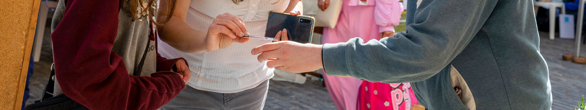 Young entrepreneur takes payment at the Young Business Showcase