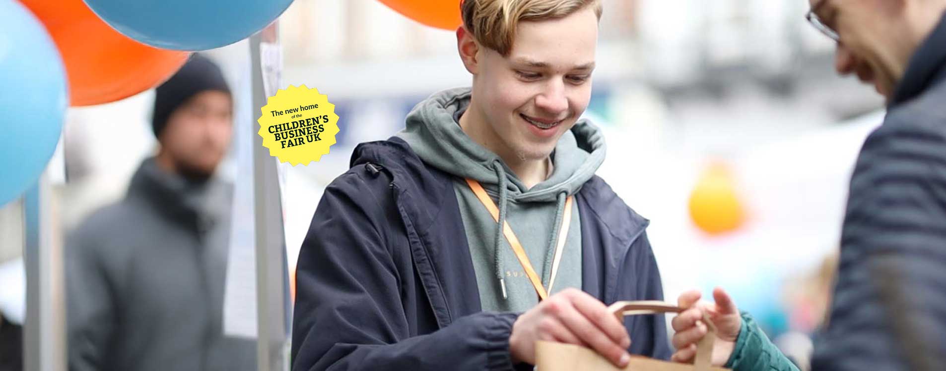 Young-entrepreneur-hands-over-bag-at-the-Young-Business-Showcase_Badge