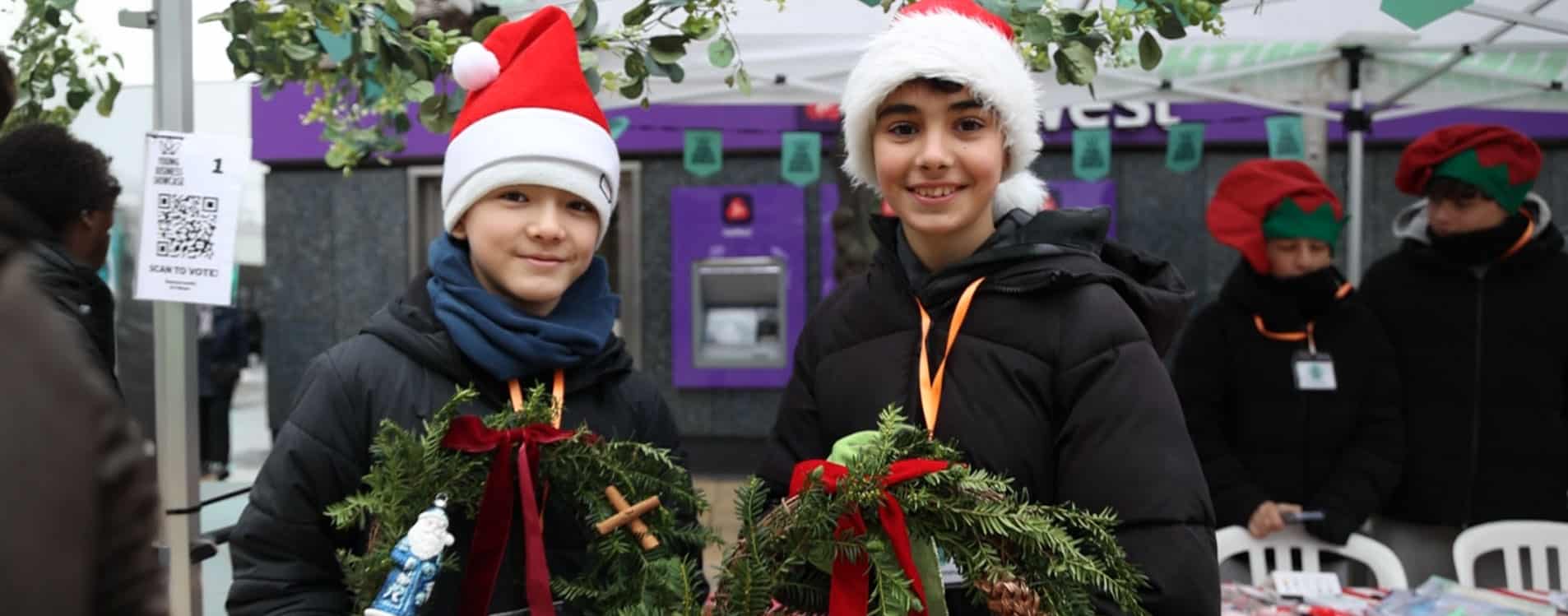 Two-entrepreneurs-sell-wreaths-at-the-Young-Business-Showcase
