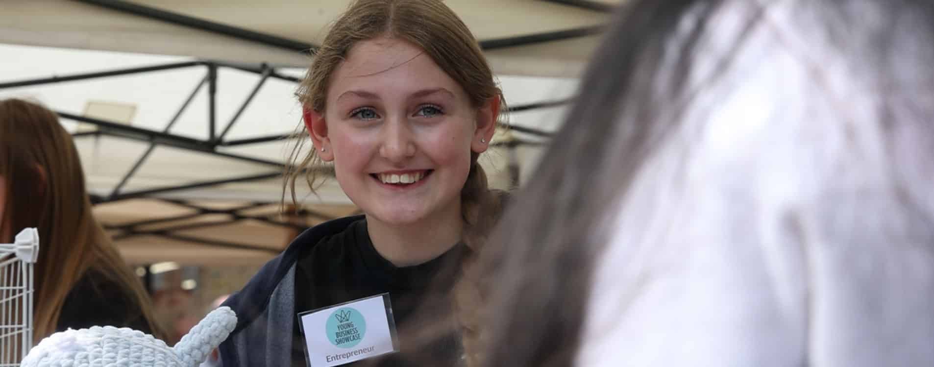 Young-entrepreneur-smiles-at-the-Young-Business-Showcase